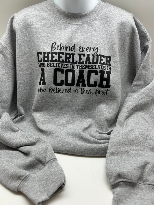 "Behind Every Cheerleader who believes in themselves is a Coach that believed in them first" Grey Crewneck Sweater